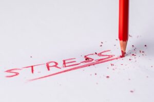 a red pencil writing on a white paper