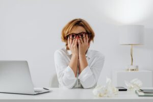 a woman covering her face with her hands